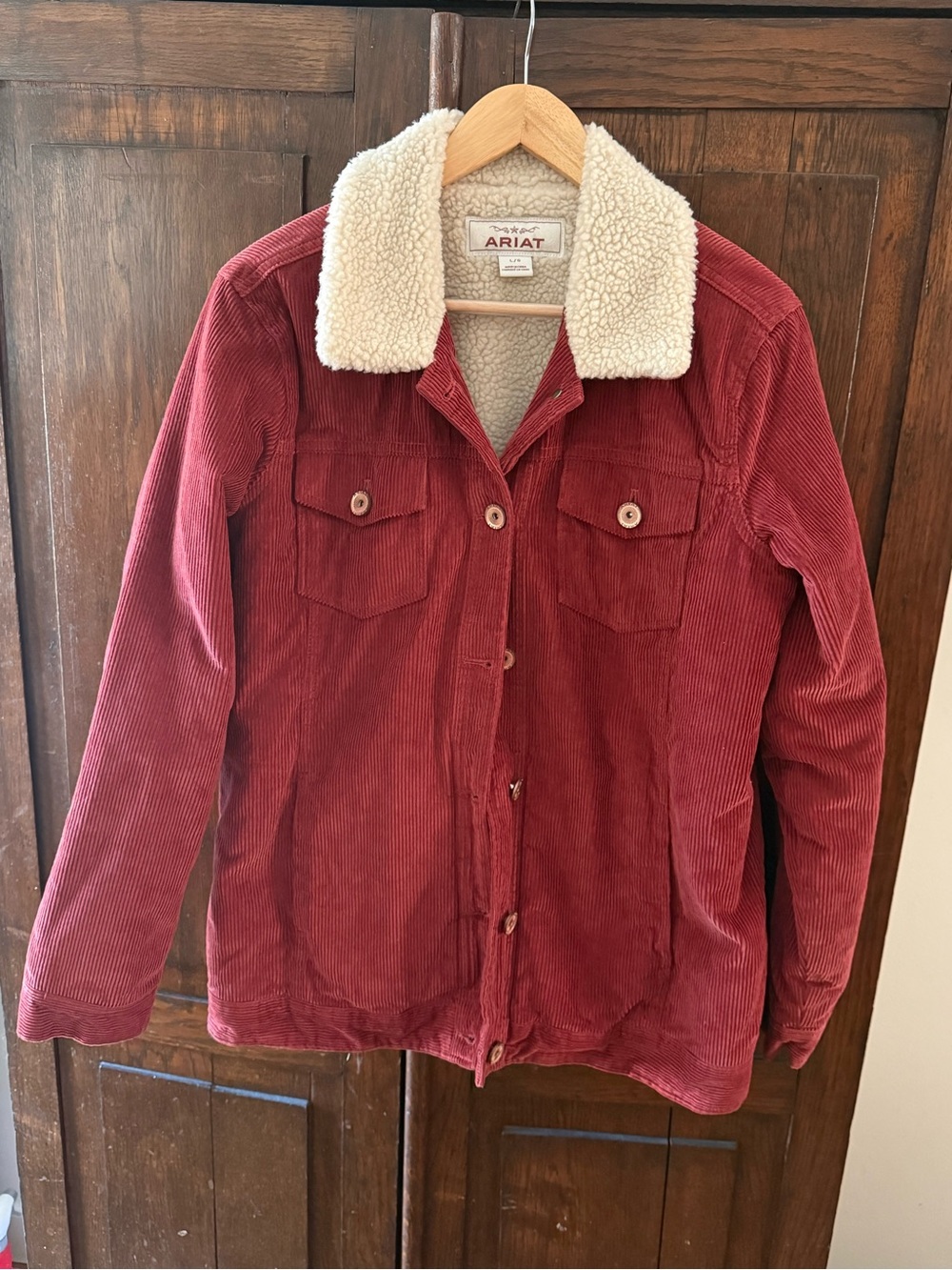 Ariat Women's Rust Red Corduroy Jacket with Cream Sherpa Collar and interior.